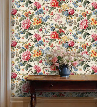 Garden-inspired wallpaper with mixed florals shown in elegant entryway with antique wooden console