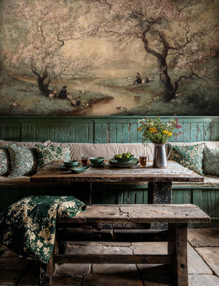 Garden scene wall mural with blossoming trees and pastoral setting in rustic kitchen with wooden bench