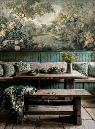 Garden scene wallpaper with herons and peonies in sage green, shown in rustic dining room with wooden benches