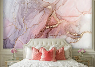 geode marble wallpaper in soft pink tones behind tufted headboard with coral accent pillows