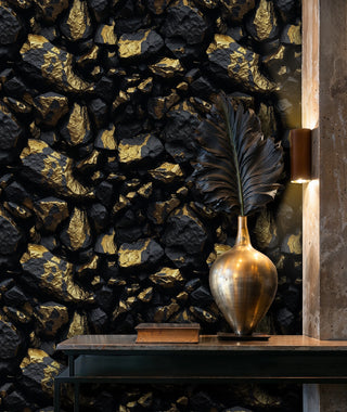 Gilded stone texture wallpaper with black rocks and gold accents, displayed in modern entryway with brass vase