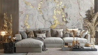 Glamorous living room featuring a textured gold concrete wall mural behind a light sectional sofa with a decorative gold lamp.