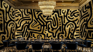 Gold Arabic script wallpaper displayed in elegant dining room with crystal chandelier