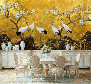 Gold chinoiserie wall mural with cranes and blossoms, displayed in a classic dining room with porcelain vases