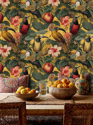 Gold toucan and hibiscus wallpaper, in a rustic dining space with wooden table and bowl of oranges