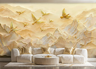 Golden birds and mountain relief wall mural in gold and beige, shown in a luxury living room with cream sofa