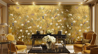 Golden botanical wallpaper with blooming branches displayed in ornate living room with marble coffee table