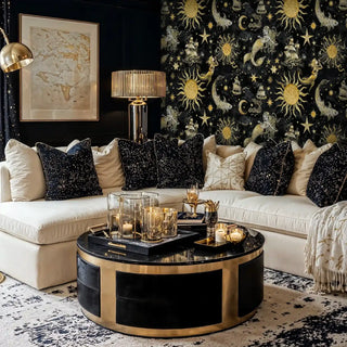 Golden celestial mural with ships and mermaids displayed in modern living room with cream sectional sofa