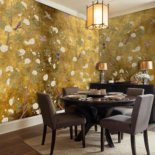 Golden floral wallpaper with songbirds in intimate dining space with contemporary pendant lighting