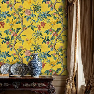 Golden fruit tree wallpaper with detailed botanical elements, displayed in elegant room with blue and white porcelain