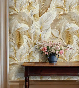Golden leaf pattern wallpaper in warm honey tones, styled in elegant hallway with antique wooden console