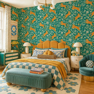 Golden leopard and floral vine wall mural on teal ground in a bold bedroom with scalloped velvet headboard