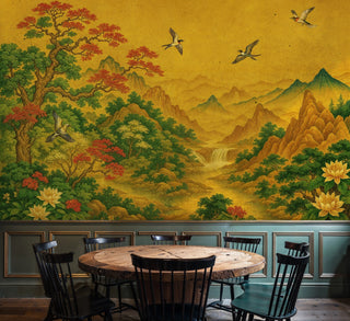 Golden mountain landscape wall mural with flying cranes, shown in dining room with round wooden table