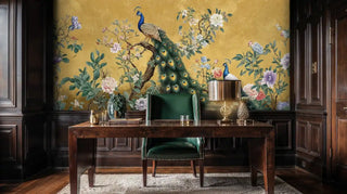 Golden peacock wallpaper with florals shown in elegant study with wooden desk and green chair