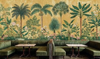 Golden tropical wall mural with coconut palms and banana plants, featured in upscale restaurant dining room with green leather banquettes
