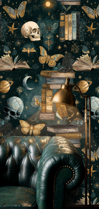 Gothic celestial wallpaper with golden butterflies and skull motifs on dark teal, in cozy reading nook with brass task lamp
