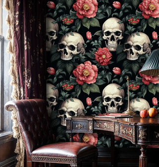 Gothic floral skull pattern wallpaper with coral blooms, shown in study with antique wooden desk