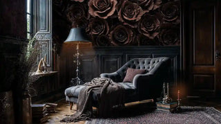 Gothic rose wallpaper featuring deep burgundy florals in dark study with tufted chair and brass lamp