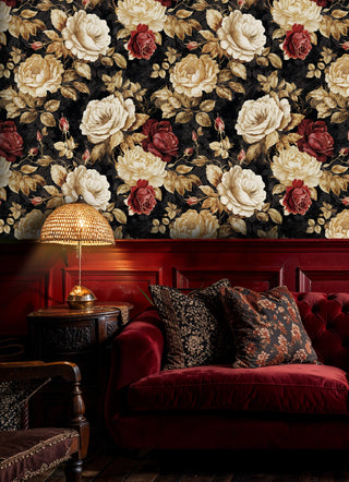 Gothic rose wallpaper with cream peonies and burgundy roses on black background, displayed in luxurious living room with red velvet sofa