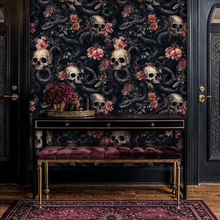 Gothic serpent skull wallpaper in sophisticated entryway with gold-trimmed burgundy bench