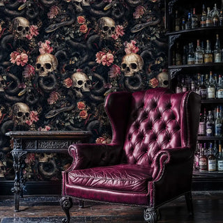 Gothic skull wallpaper with coiling serpents displayed in luxury bar with burgundy leather armchair