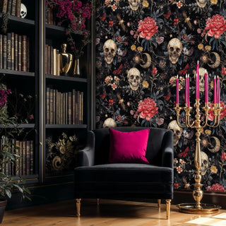 Gothic skull wallpaper with coral peonies and moons, styled in elegant study with dark furniture and gold candelabra