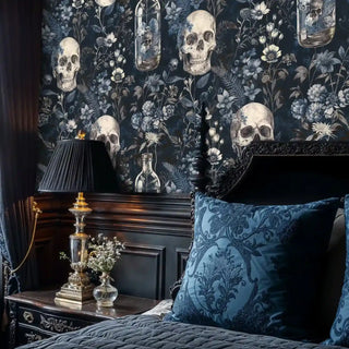 Gothic skull wallpaper with glass bottles and florals, styled in luxurious bedroom with ornate headboard