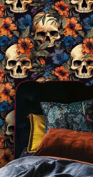 Gothic skull wallpaper with orange and blue tropical blooms in luxurious bedroom with green velvet headboard