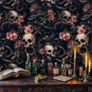 Gothic wallpaper with skulls, serpents and pink florals in mystical study with glass bottles and candles