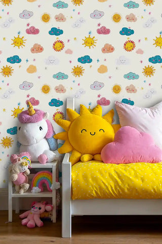 Happy sun and clouds kids wallpaper with smiling faces in bright colors, displayed in child's bedroom with white bed