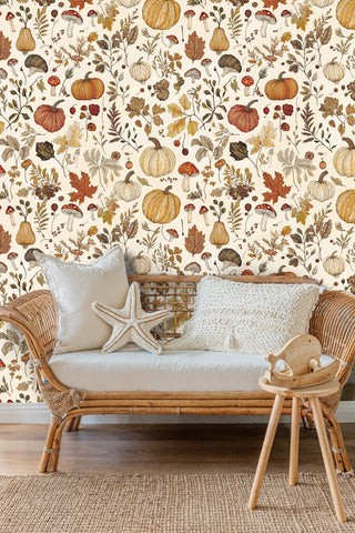 Harvest pumpkin wallpaper with fall foliage and mushrooms, in a nursery with a rattan daybed and starfish cushion