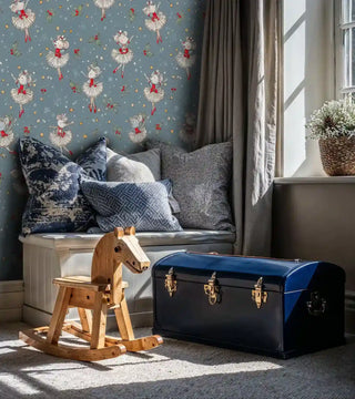 Holiday ballet wallpaper with mice dancers and snowflakes, displayed in window seat nook with blue pillows