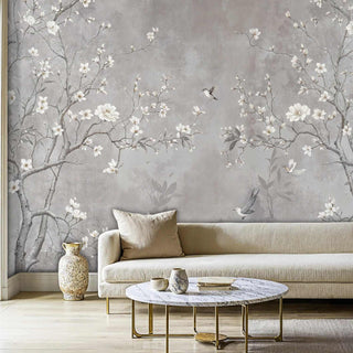 Hummingbird cherry blossom wallpaper with delicate white flowers, showcased in modern living room with marble coffee table