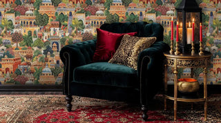 Indian palace garden wallpaper featuring ornate buildings and elephants in elegant living room with green velvet armchair