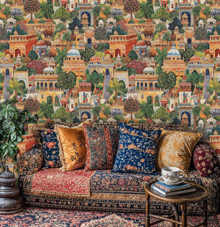 Indian palace garden wallpaper with ornate architecture and animals shown in traditional sitting room with patterned sofa