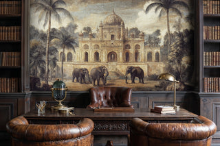 Indian palace wall mural with elephants and palm trees in warm gold tones, in a dark study with globe and bookshelves