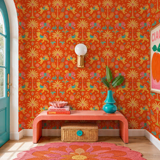 Indian tiger wallpaper with golden palms and florals on orange, in a colorful entryway with pink bench
