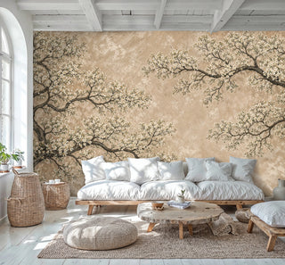 Ivory blossom tree wall mural on beige backdrop in airy Scandinavian living room with woven baskets and floor pouf
