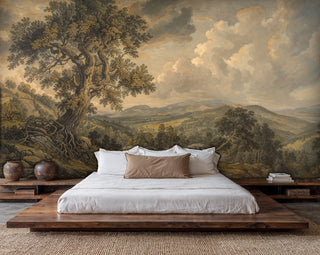 Landscape wall mural showing ancient tree and rolling hills, displayed in modern bedroom with platform bed