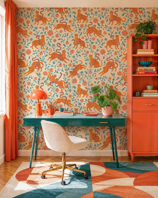 Leopard and floral pattern wallpaper on cream background, in a home office with teal writing desk