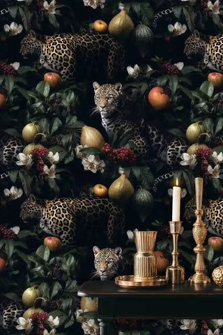 Leopard botanical wallpaper featuring spotted big cats among fruits and foliage, displayed with gold candlesticks