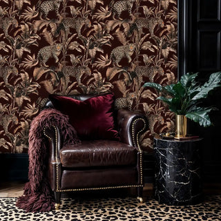 leopard jungle wallpaper, sepia palms on burgundy, with leather chair and marble table