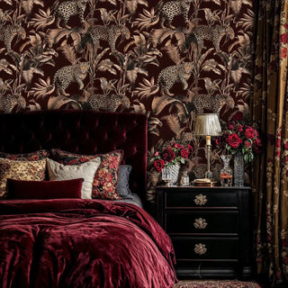 leopard jungle wallpaper, sepia palms on burgundy, with tufted headboard and bedside lamp