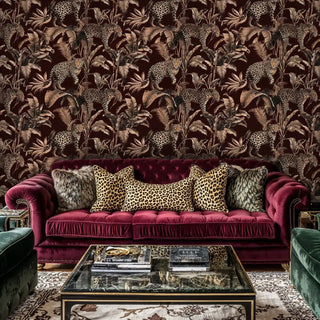 leopard jungle wallpaper, sepia palms on burgundy, with velvet sofa and glass coffee table