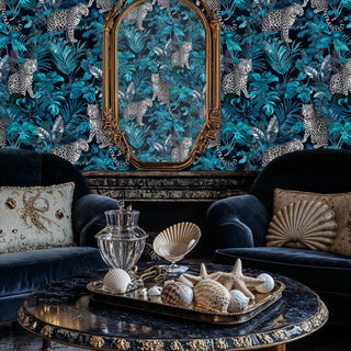 Leopard jungle wallpaper with spotted cats and teal botanicals, shown in sophisticated living room with ornate mirror