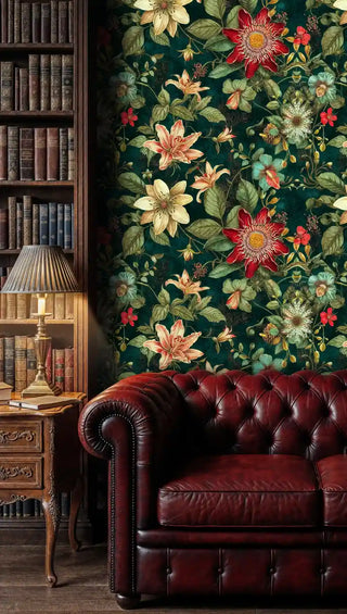 Lush floral wallpaper with passion flowers and lilies shown in classic library with burgundy leather armchair