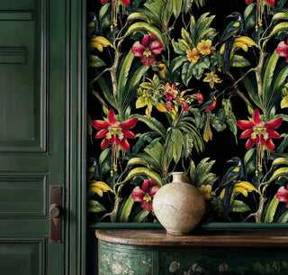 lush tropical paradise wallpaper with colorful birds shown in sophisticated entryway with weathered green console table
