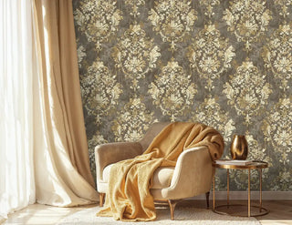 Luxurious damask wallpaper in gold tones creating cozy reading nook with velvet armchair
