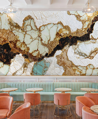 luxurious stone pattern wallpaper with gold veining, displayed in modern cafe with mint banquette seating