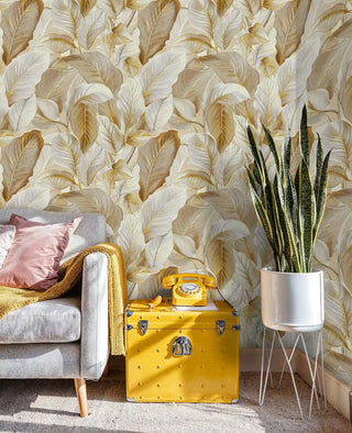 Luxurious tropical wallpaper with golden foliage design, featured in modern living room with yellow trunk table
